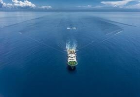 A seismic survey vessel tows streamers of ultra-sensitive hydrophones