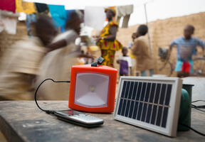 Decentralized solar power is changing people's lives in numerous households. Here, an ordinary solar panel recharges a lamp and a telephone.