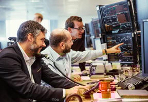 Image of traders carrying out financial transactions involving oil and gas shipments.