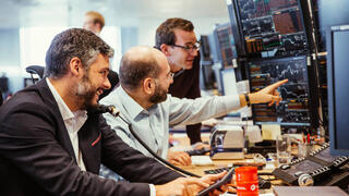 Image of traders carrying out financial transactions involving oil and gas shipments.