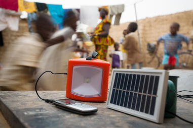 Decentralized solar power is changing people's lives in numerous households. Here, an ordinary solar panel recharges a lamp and a telephone.